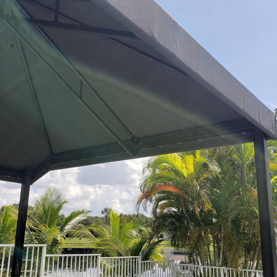 The sun is shining through the roof of a gazebo.