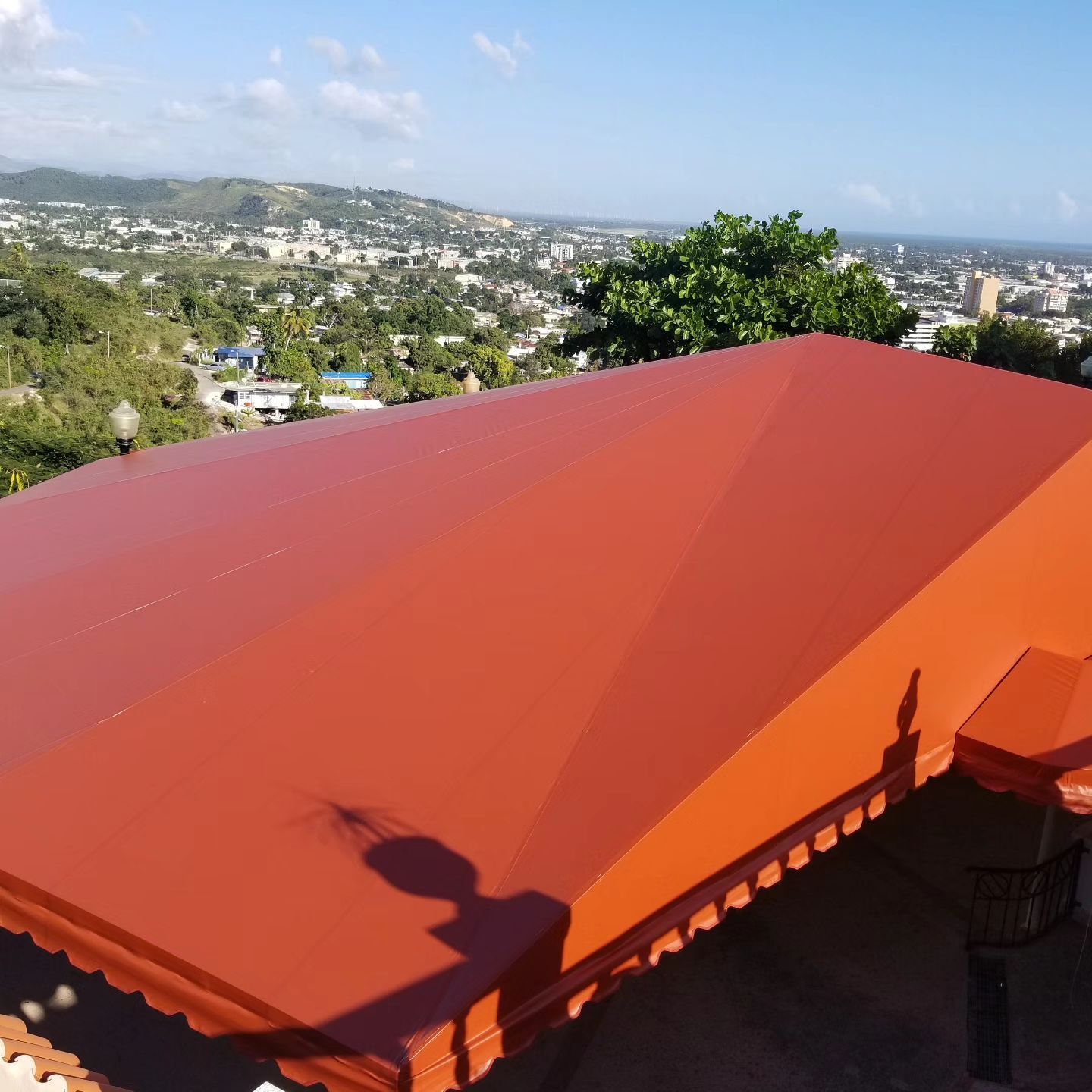 A red roof with a city in the background