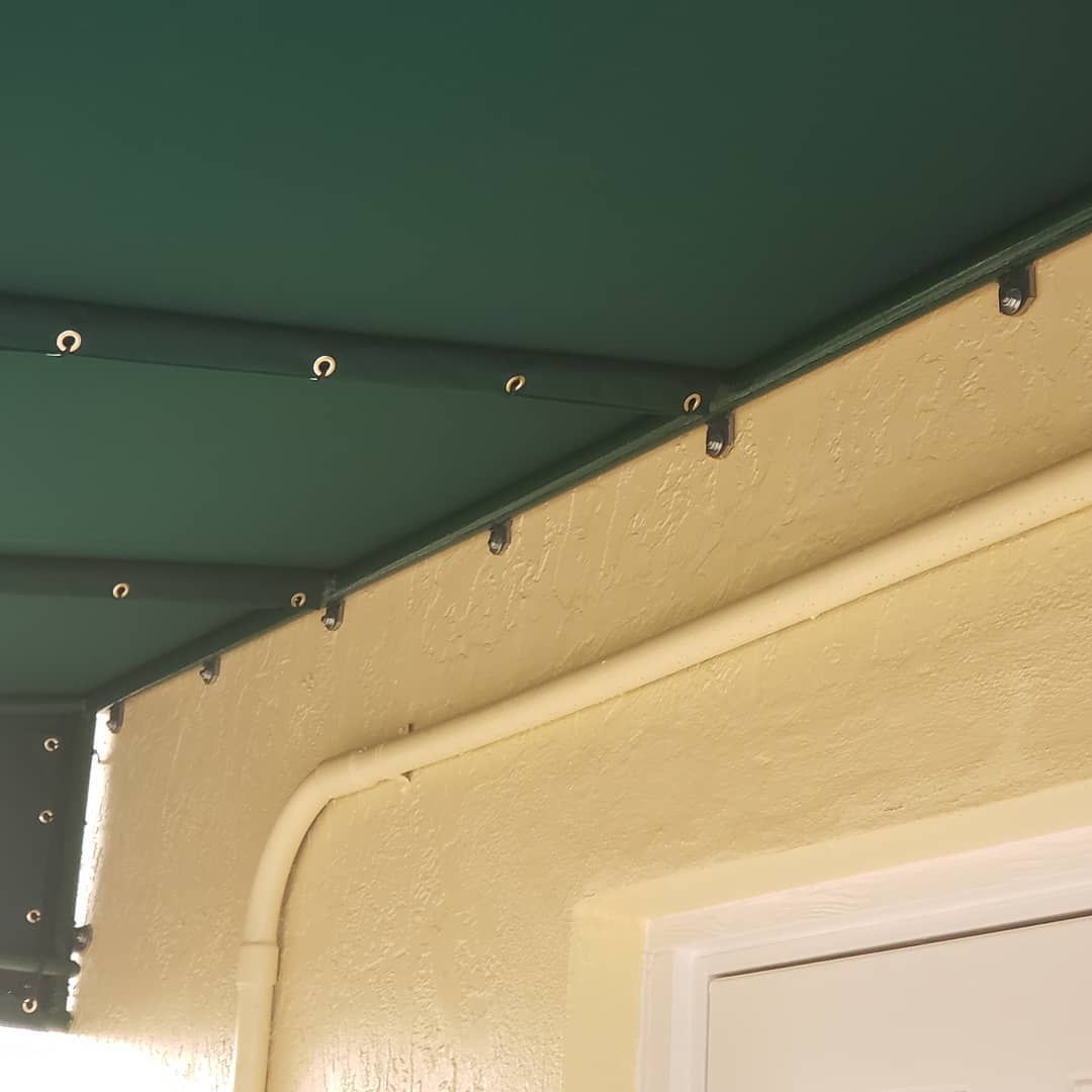A green awning is attached to the side of a building