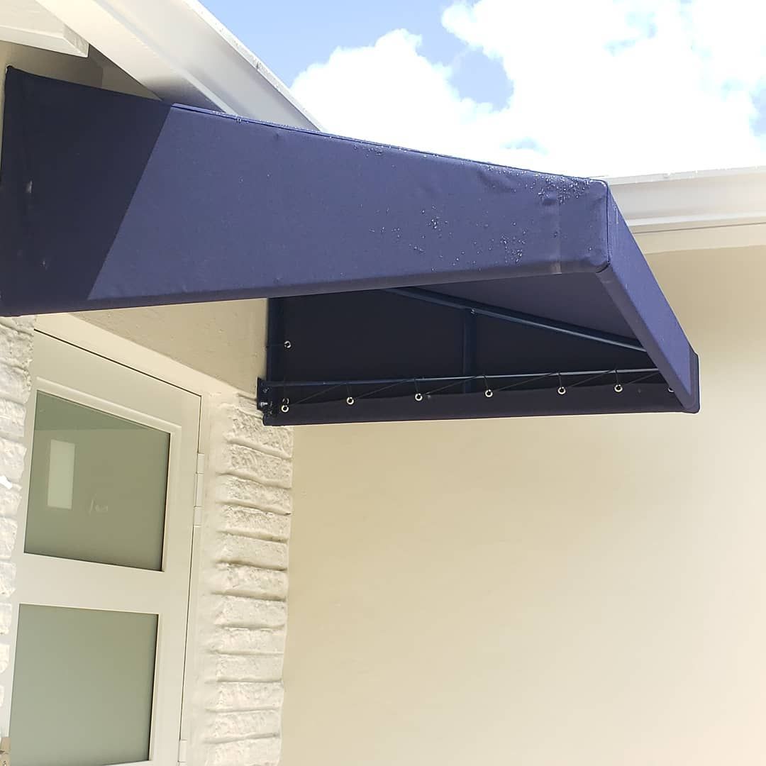 A blue awning is attached to the side of a building