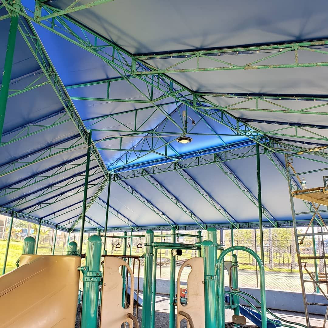 A playground with a blue roof and a slide