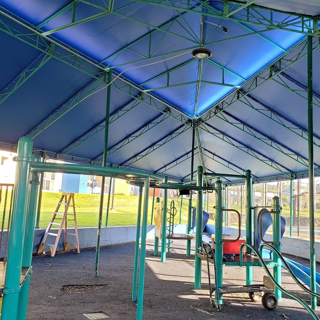 A blue and green playground with a blue roof