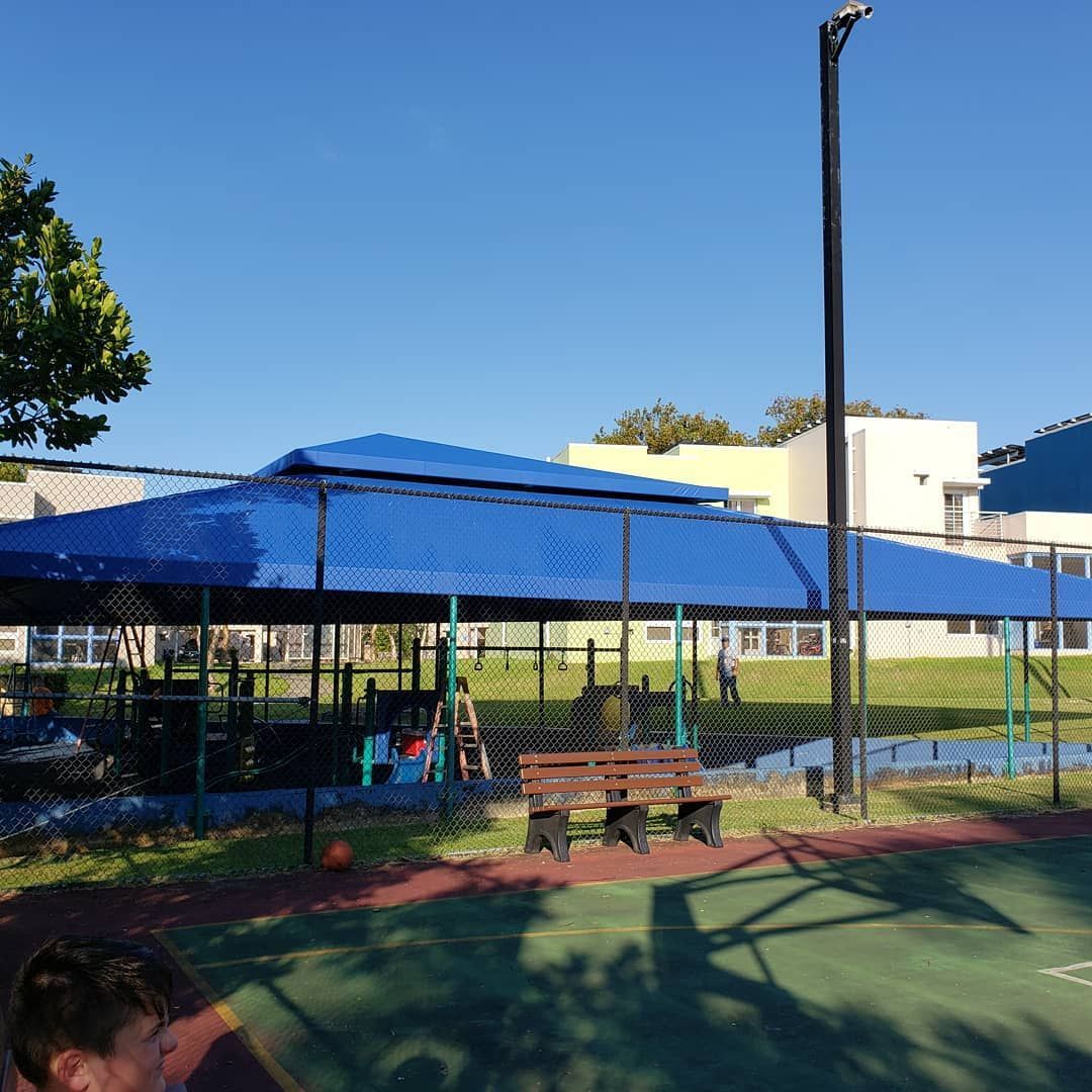 A basketball court with a blue canopy over it
