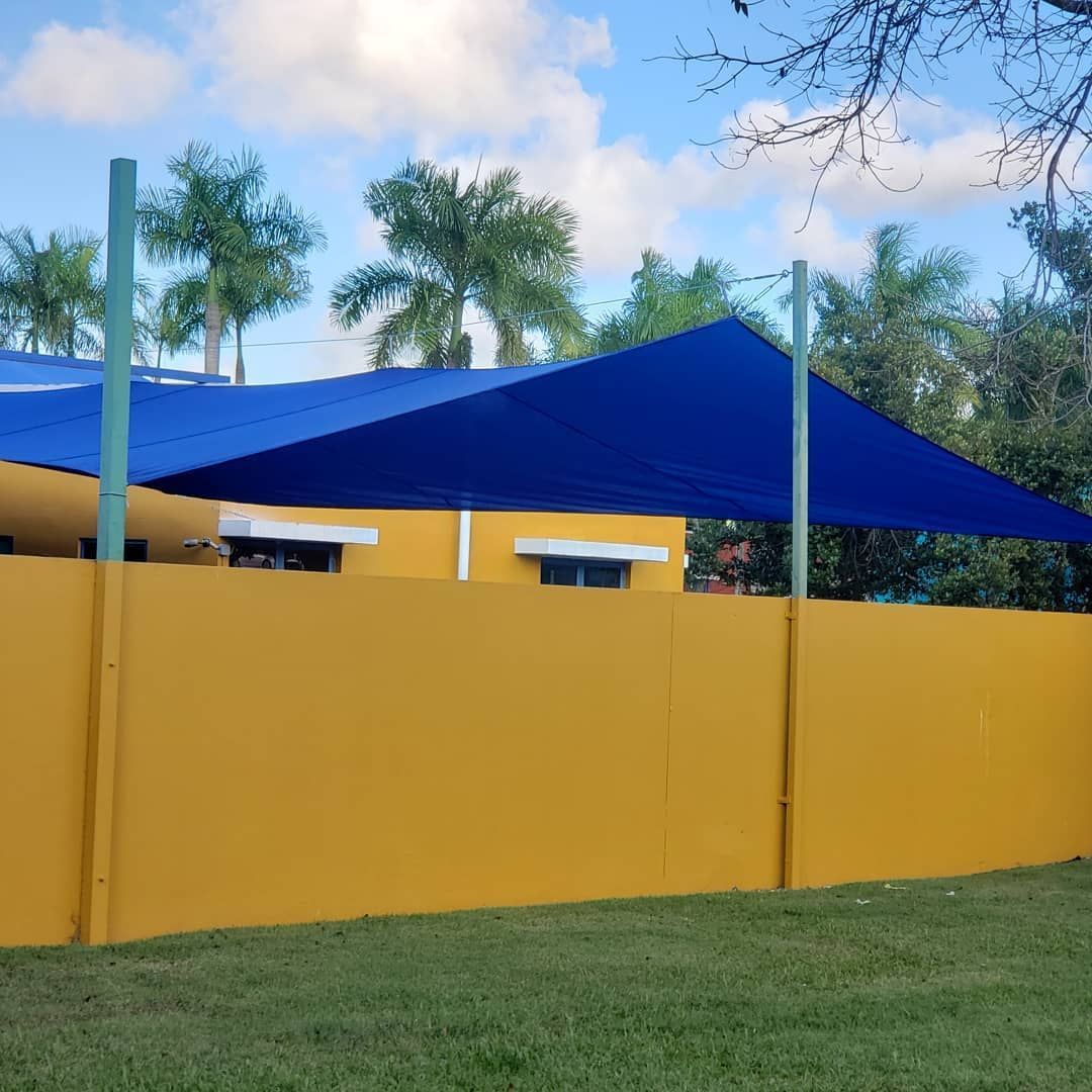 A yellow fence with a blue canopy over it