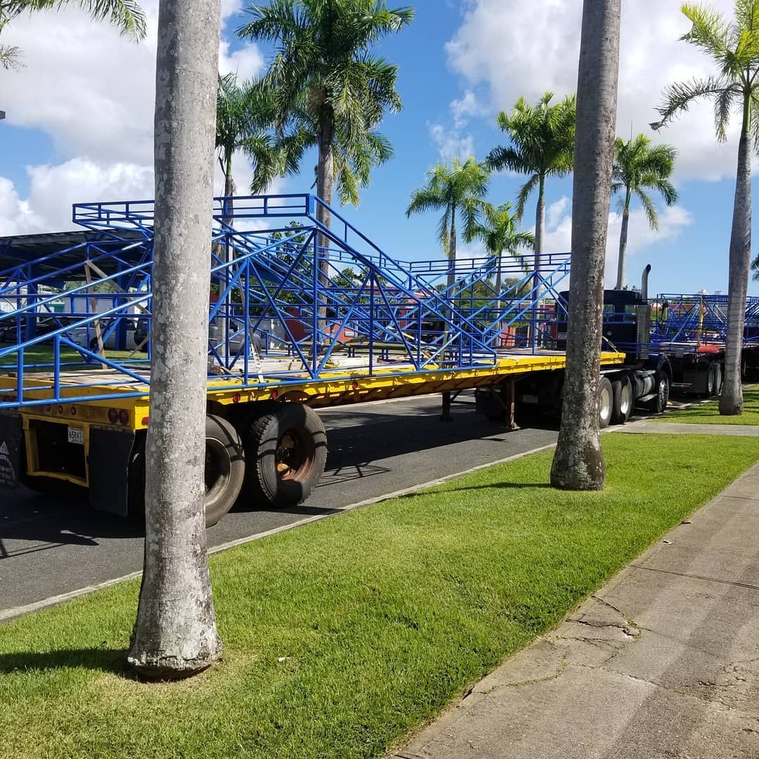 A blue and yellow trailer is parked on the side of the road