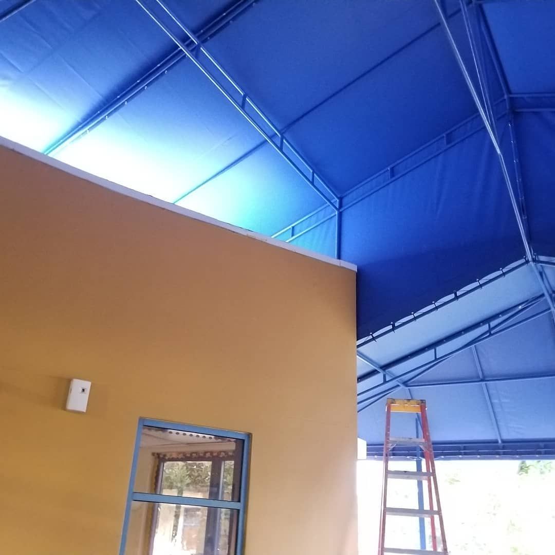 A blue awning is hanging from the ceiling of a building