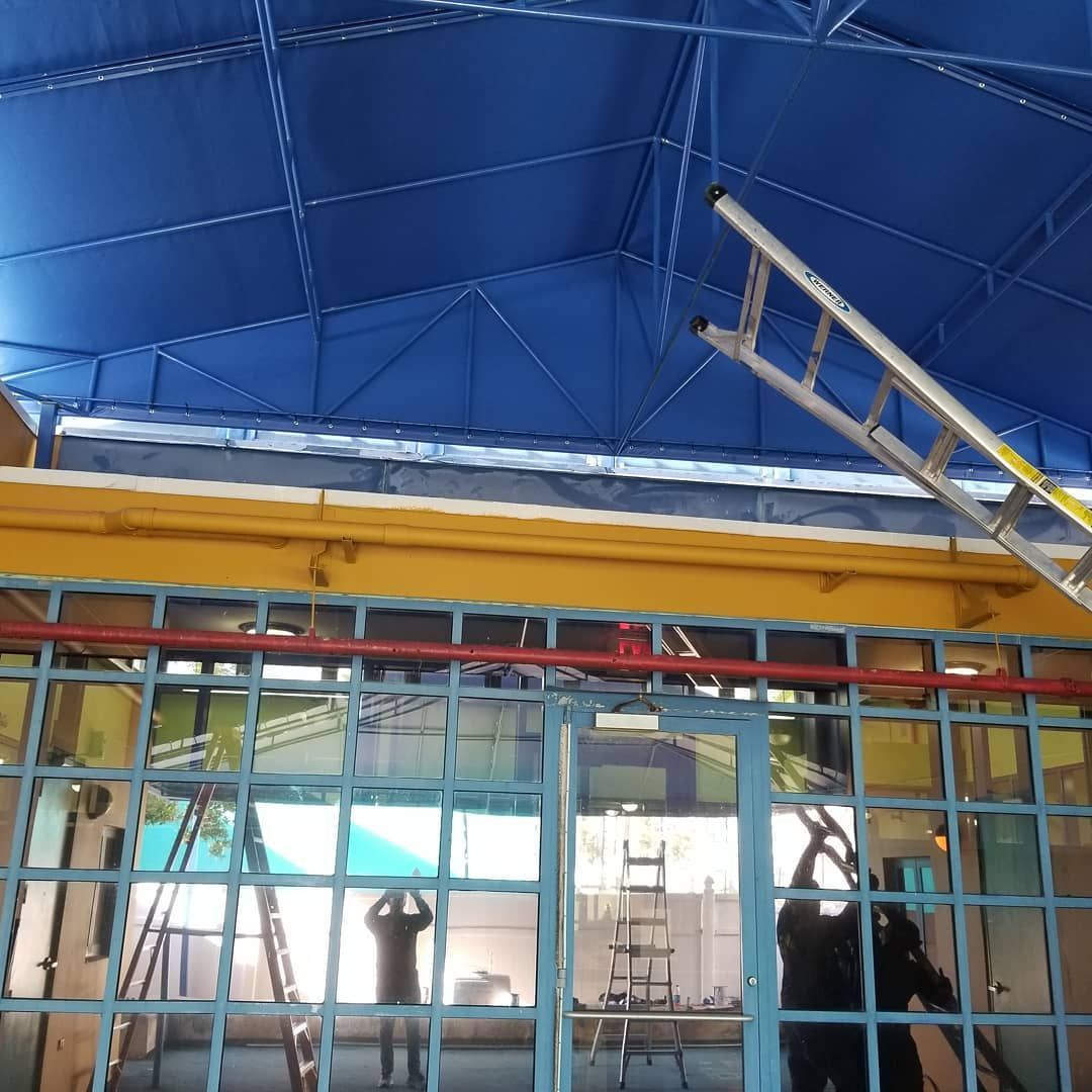 A ladder is hanging from the ceiling of a building