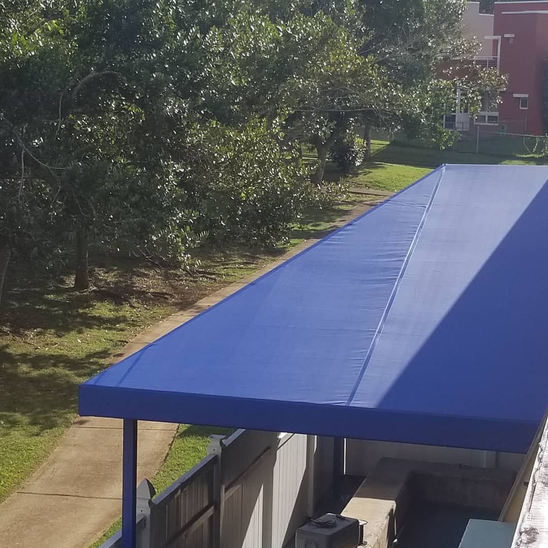 A blue awning is sitting on top of a building.