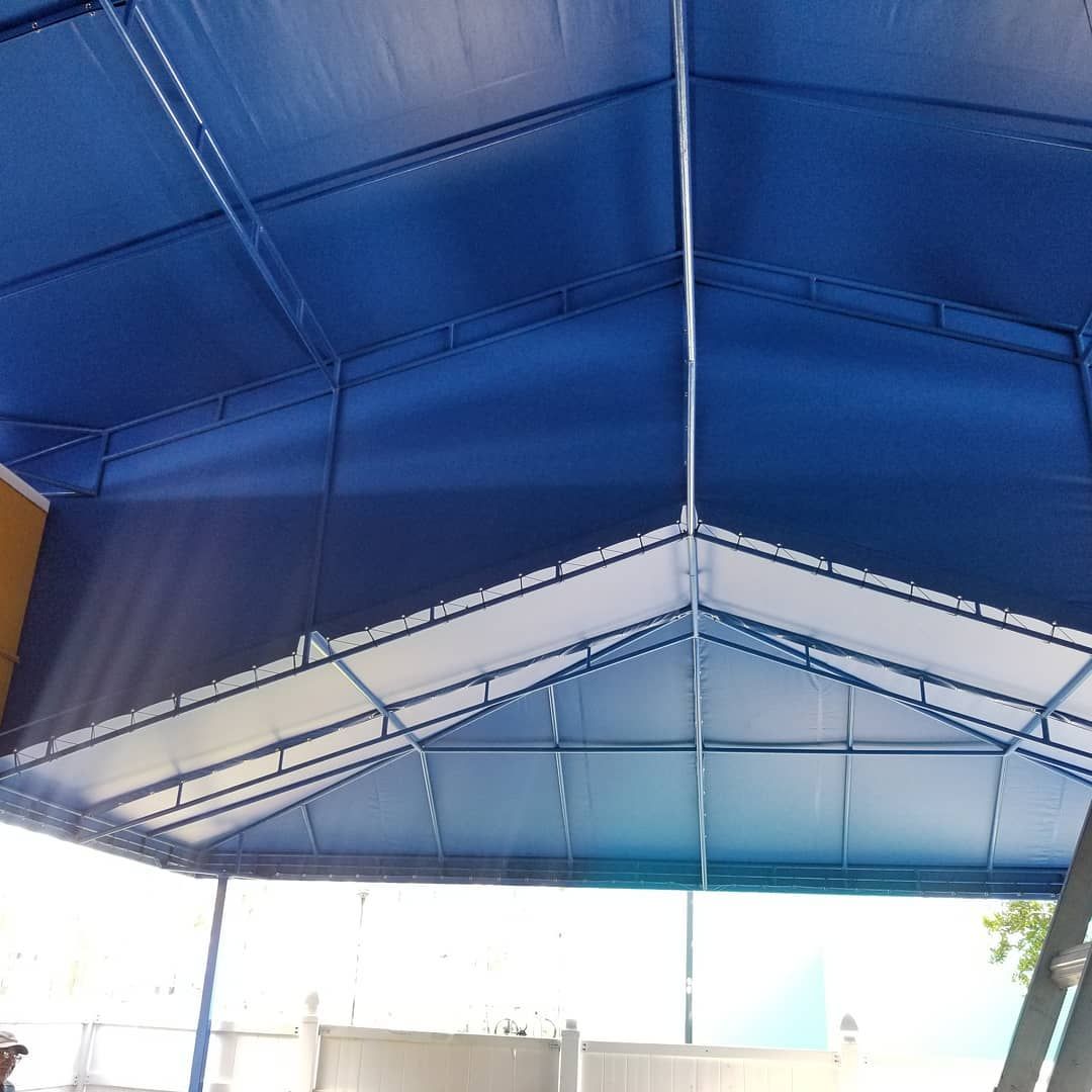 A blue and white tent with a metal frame