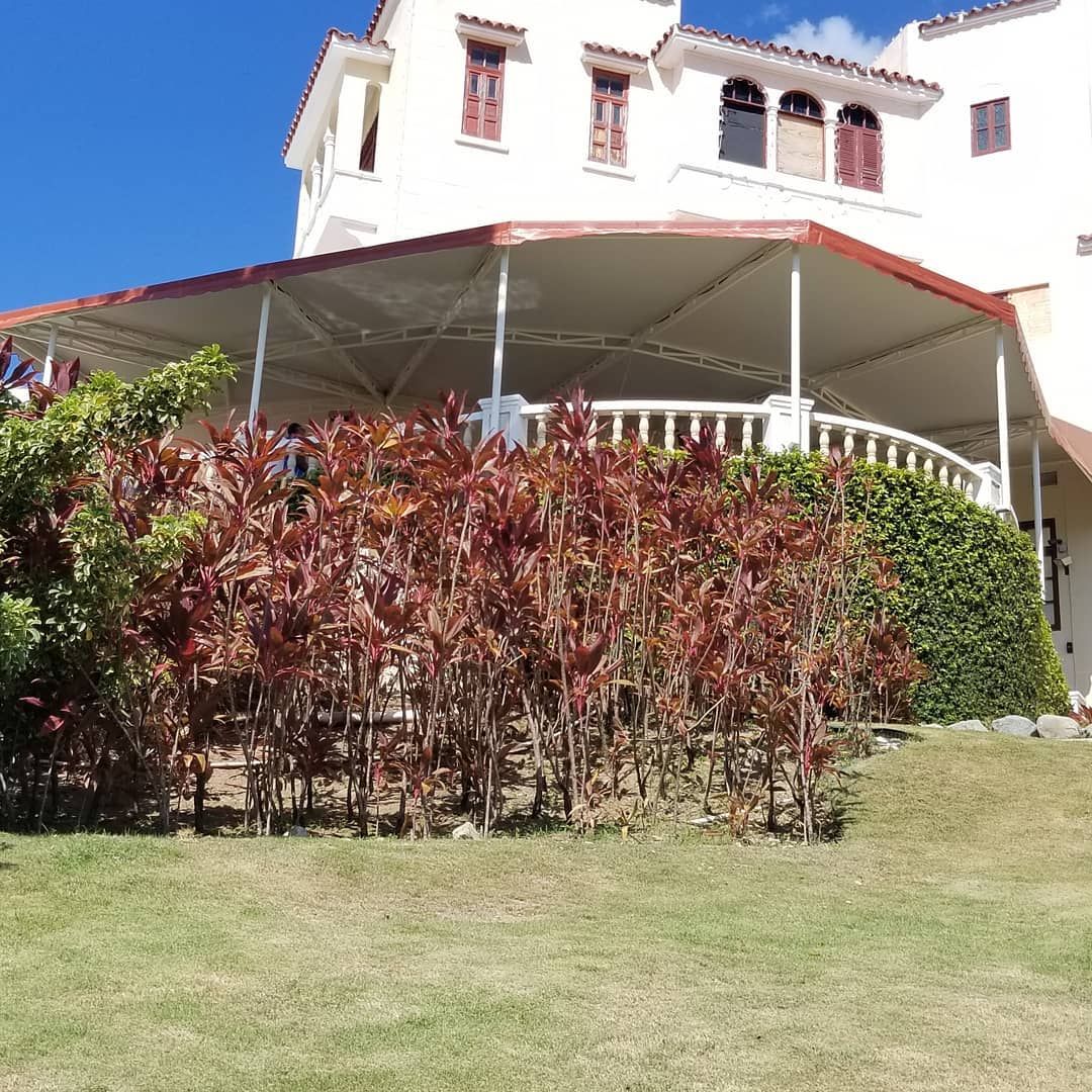 A large white house with a red awning on top of it