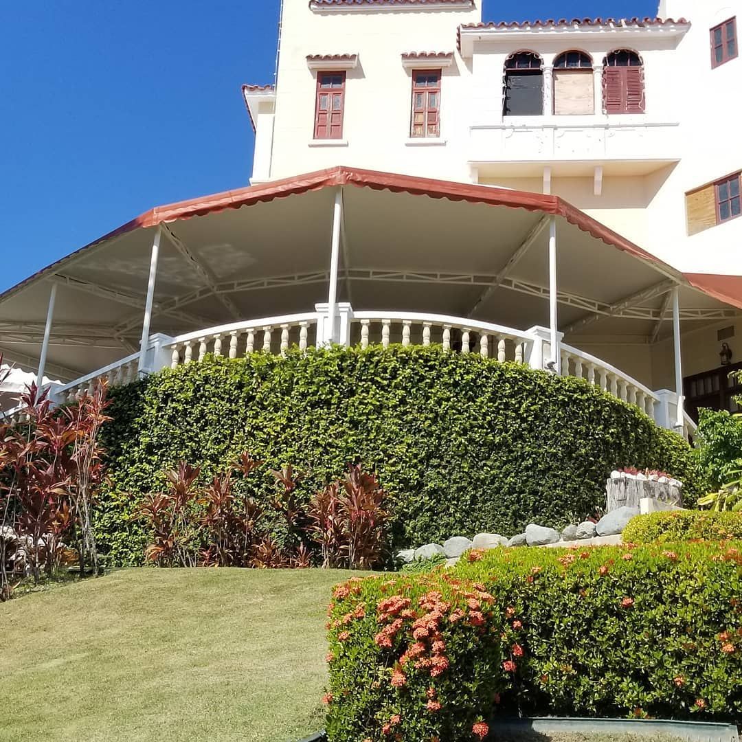 A large white building with a red awning on top of it