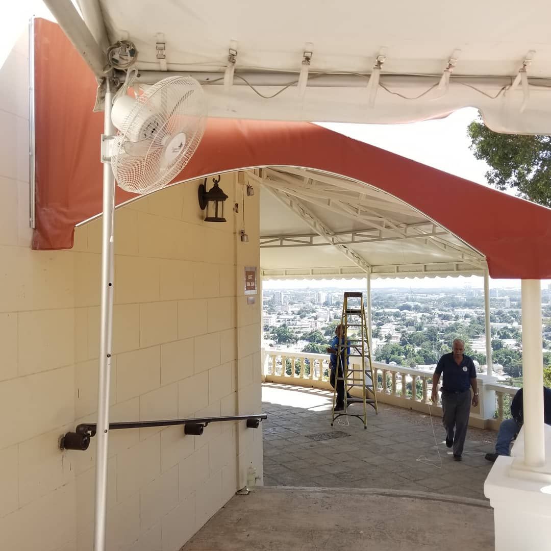 A red awning with a fan attached to it