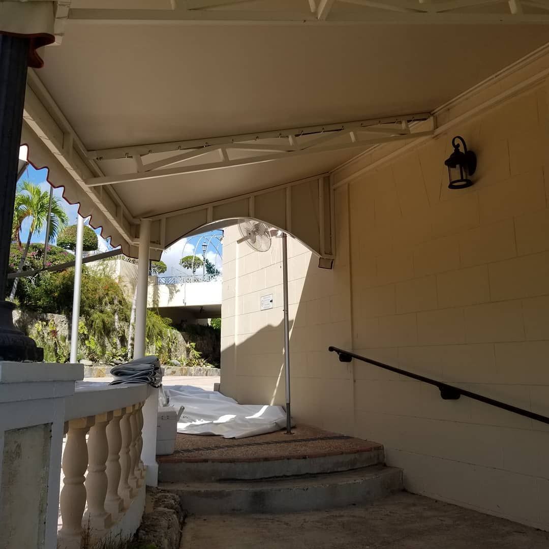 A porch with stairs and a lantern on the wall