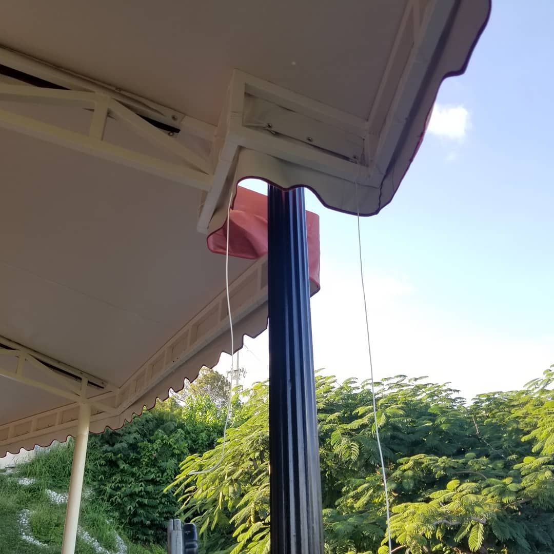 A red balloon is hanging from the ceiling of a tent.