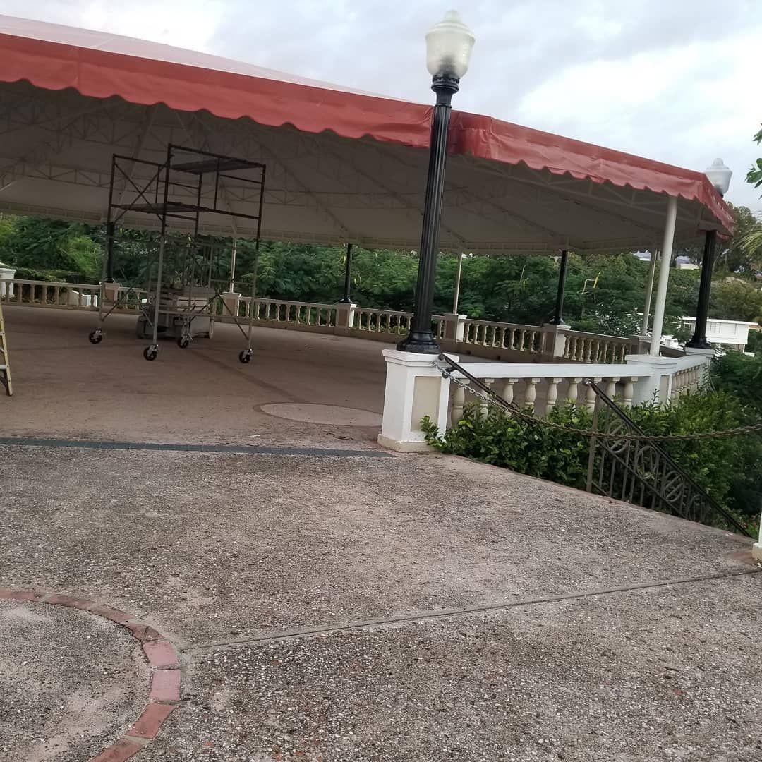 A gazebo with a red canopy and a lamp post