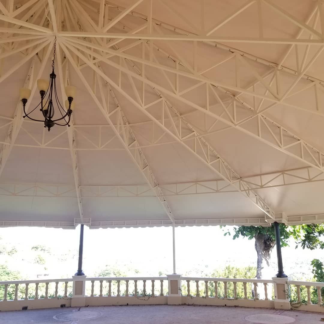 A gazebo with a chandelier hanging from the ceiling