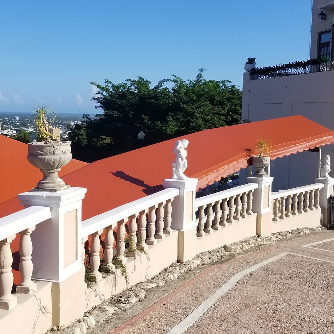 A building with a red awning and a white railing