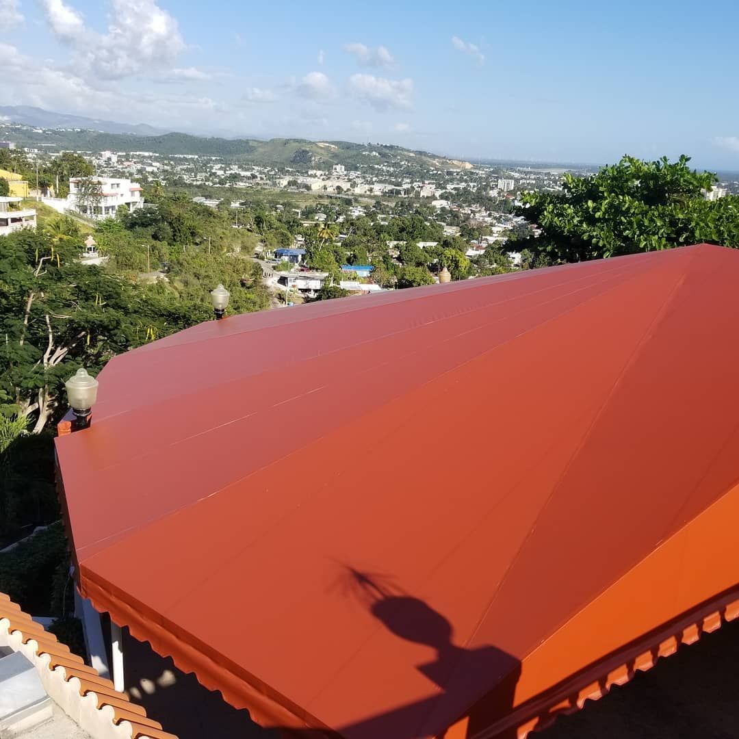 A red awning with a view of a city in the background