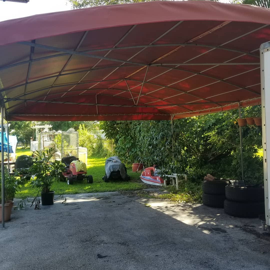 A carport with a red awning over it