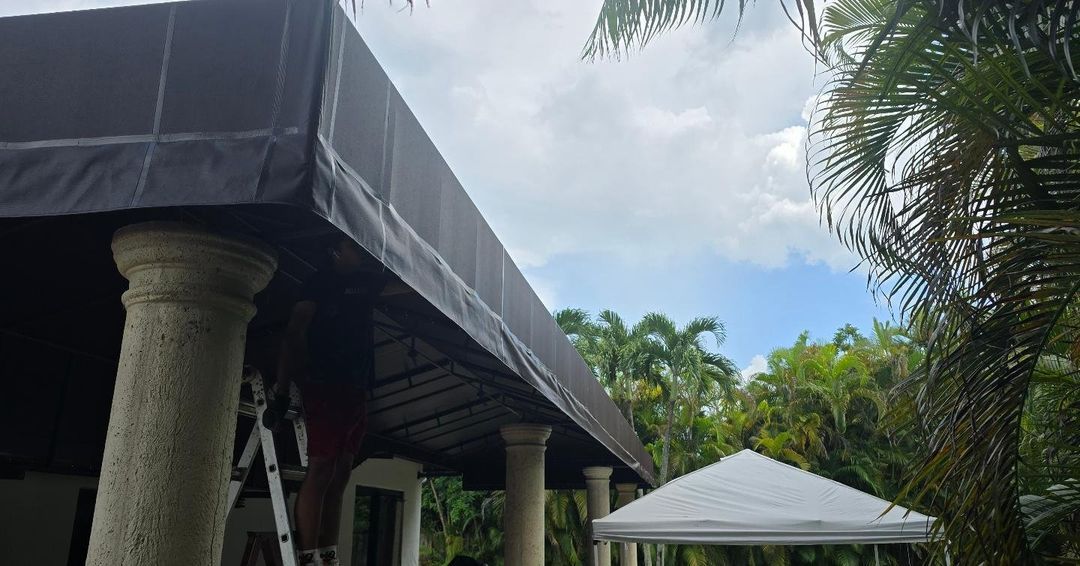 A large awning is being installed on the side of a building.