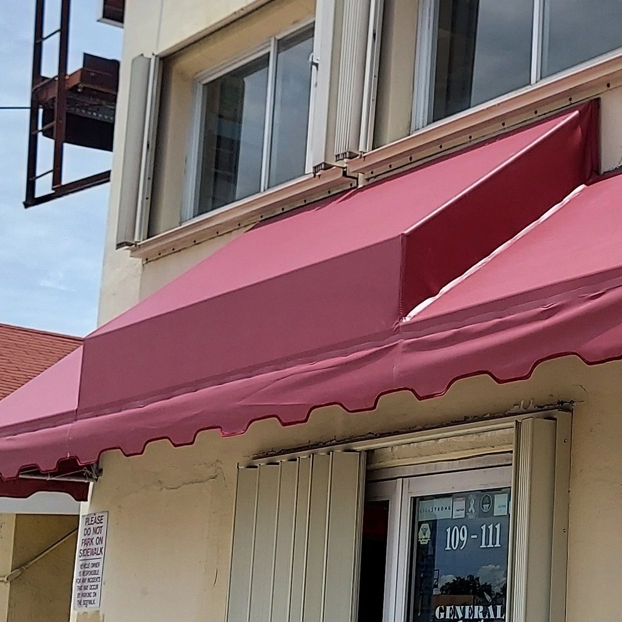 A building with a red awning on top of it