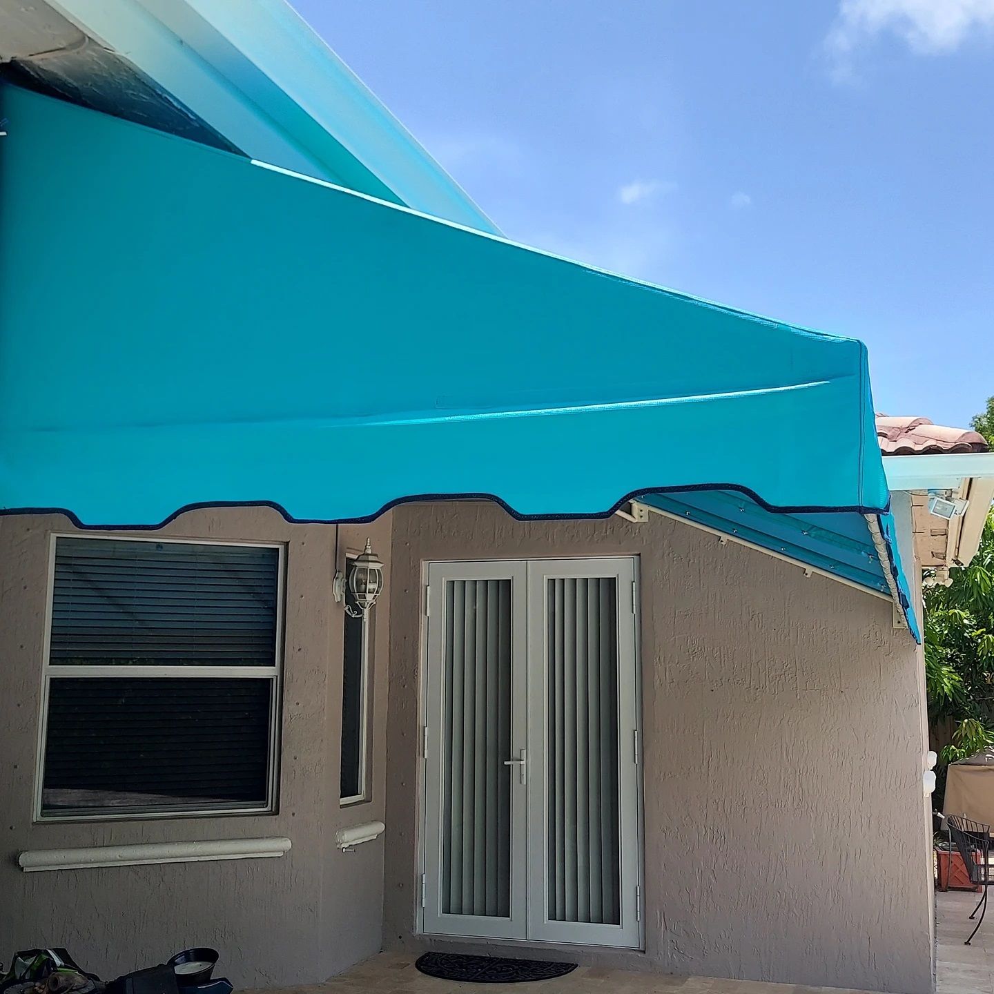 A house with a blue awning over the front door