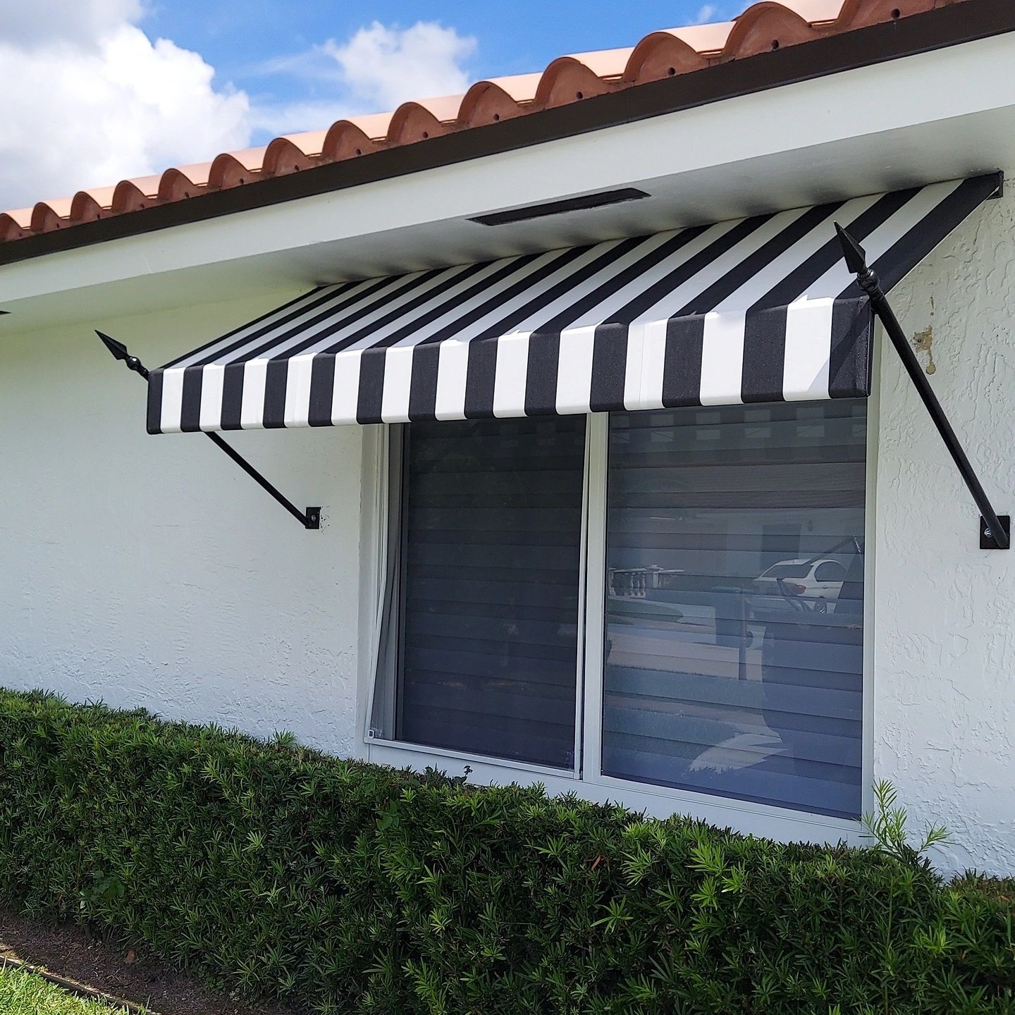 A black and white striped awning over a window