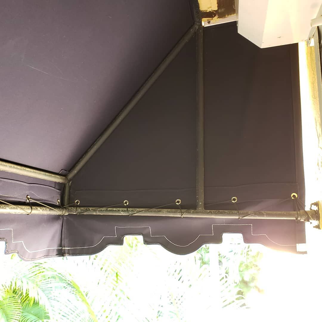 A purple awning is hanging from the ceiling of a building.