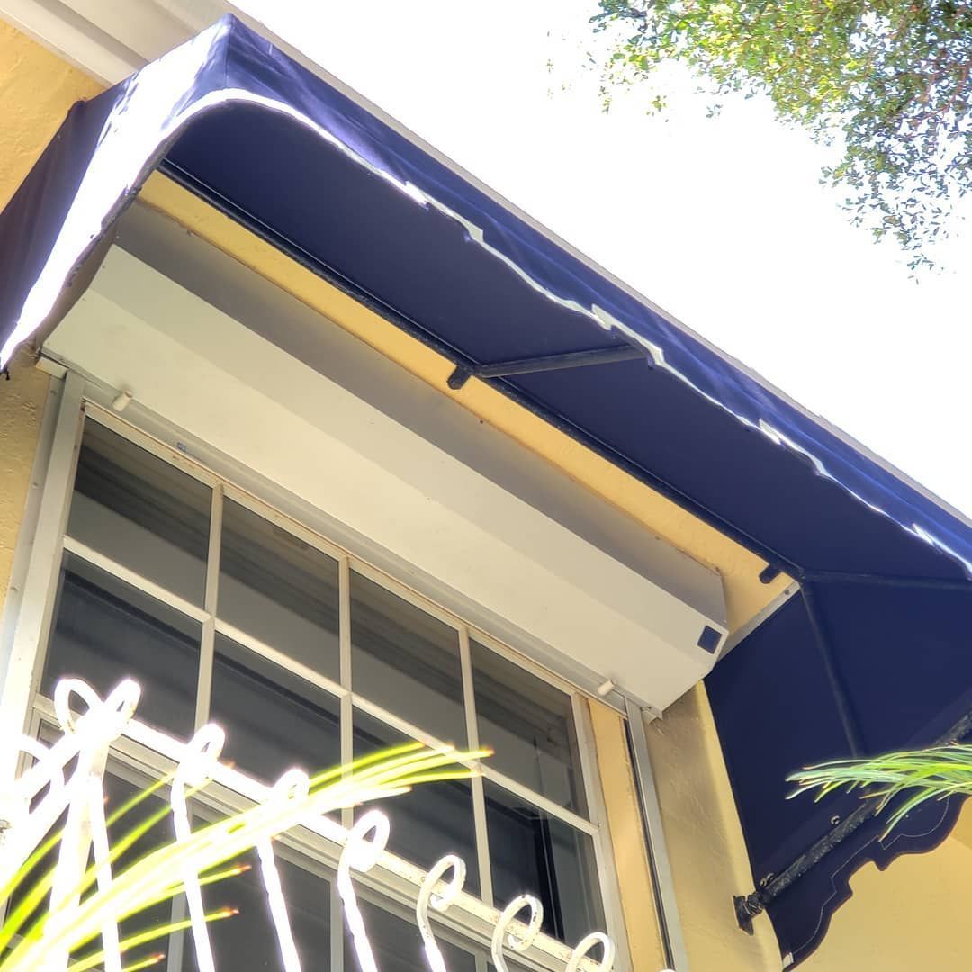 A window with a blue awning over it