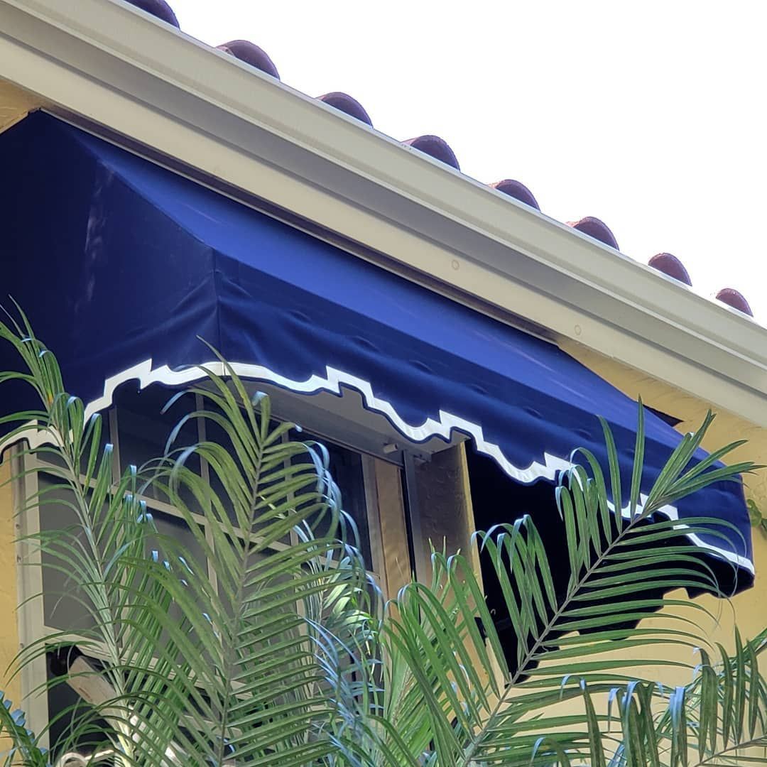 A window with a blue awning over it