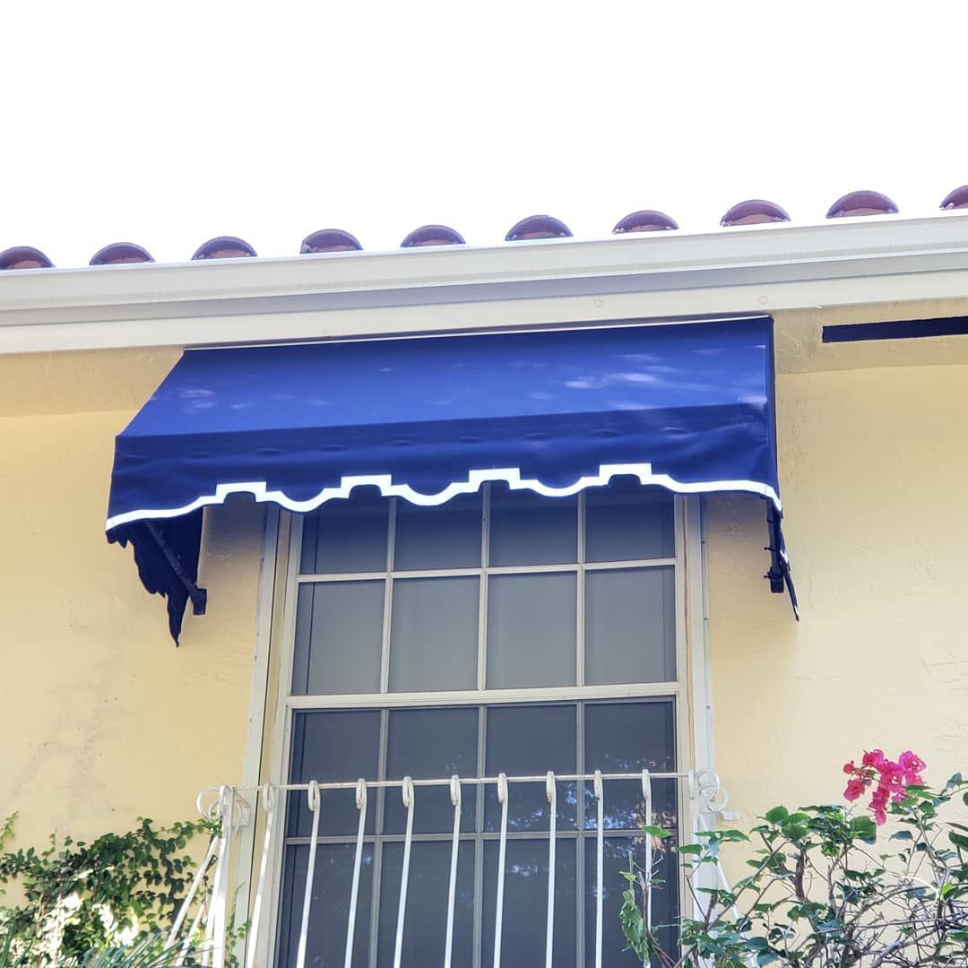 A window with a blue awning over it