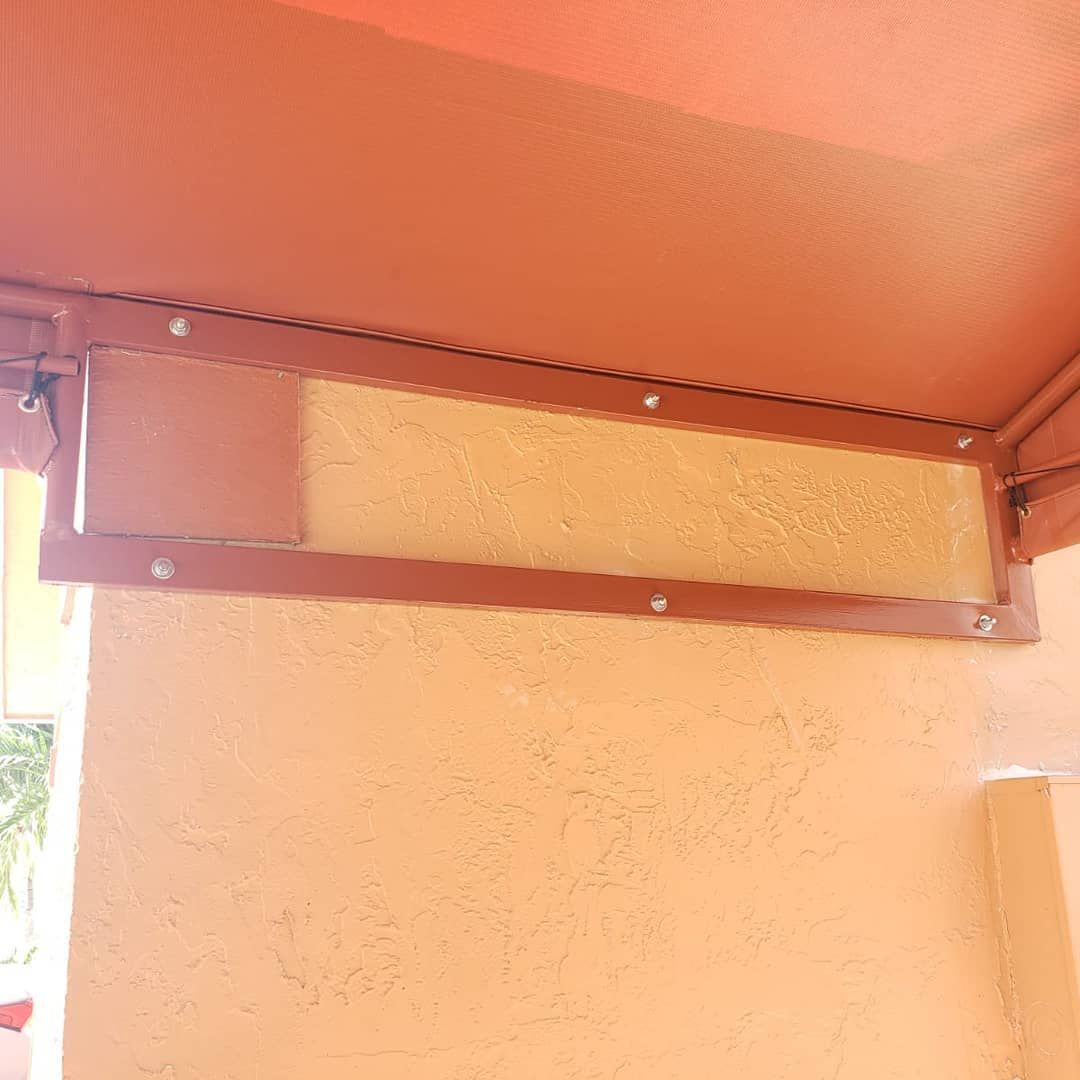 A red awning is hanging from the ceiling of a building.