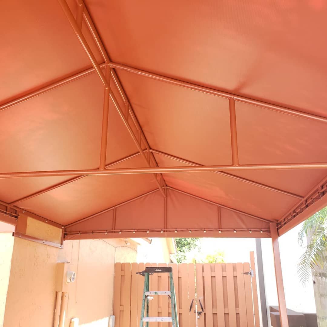 A red canopy with a ladder in front of it