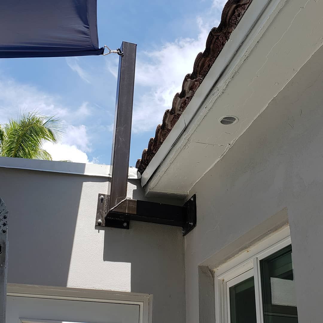 A flag is hanging from the roof of a building.