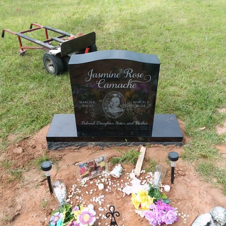 A gravestone for jasmine rose camacho is surrounded by flowers