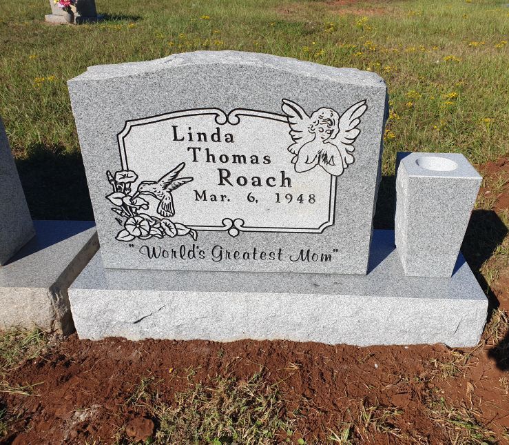 A gravestone for linda thomas roach in a cemetery