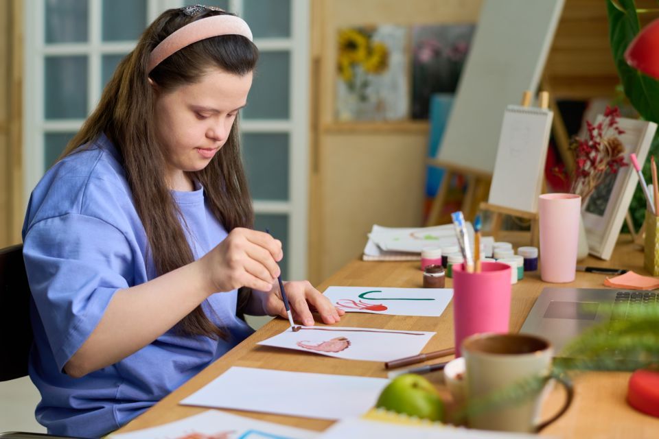 disabled girl painting on a paper