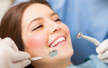 Local Dentist —Woman Getting Her Teeth Checked in Kalamazoo, MI