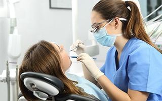 New Patient Information — Patient With Her Dentist in Kalamazoo, MI