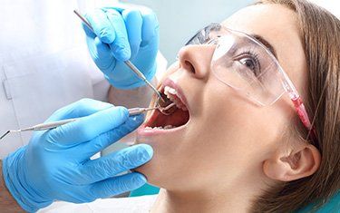 Root Canal Procedure — Woman Getting Root Canal Treatment in Kalamazoo, MI