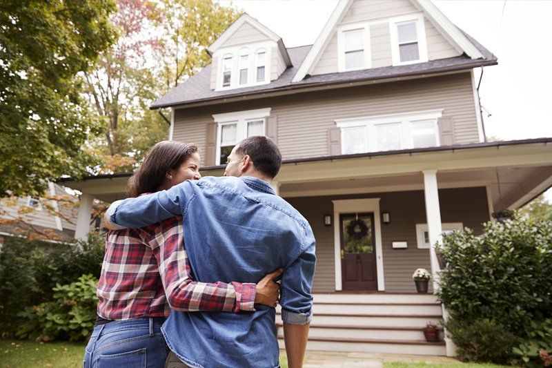 Loving Couple Walking Towards House — Chicago, IL — Clover Insurance Agency