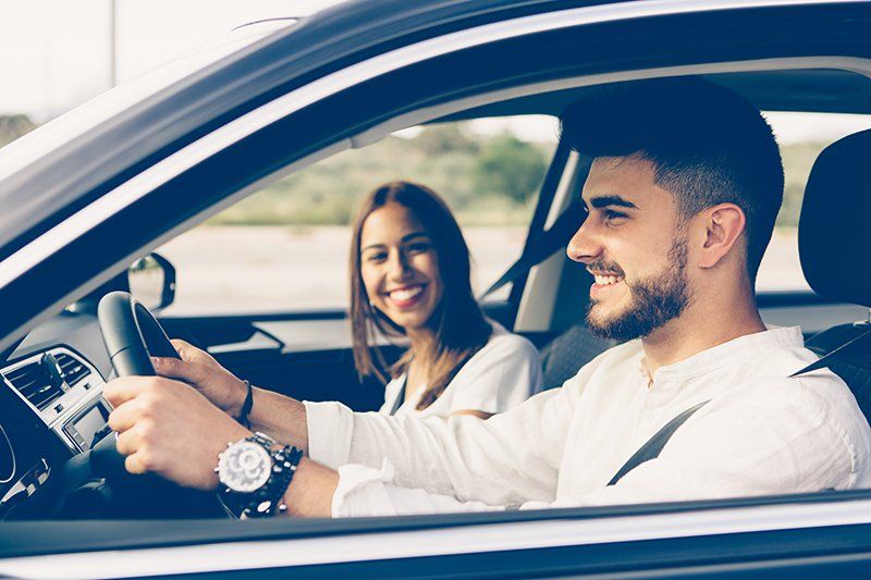 Happy Young Man Driving A Car — Chicago, IL — Clover Insurance Agency