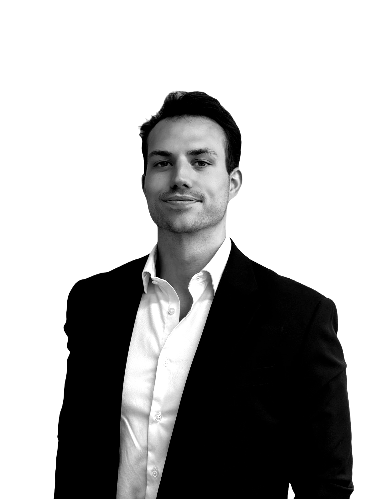A man in a suit and white shirt is standing in front of a white background.