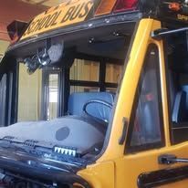 A yellow school bus is parked in a garage.