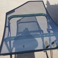 A shadow of a person is cast on a glass table.