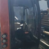 A man is sitting in the driver 's seat of a tractor.