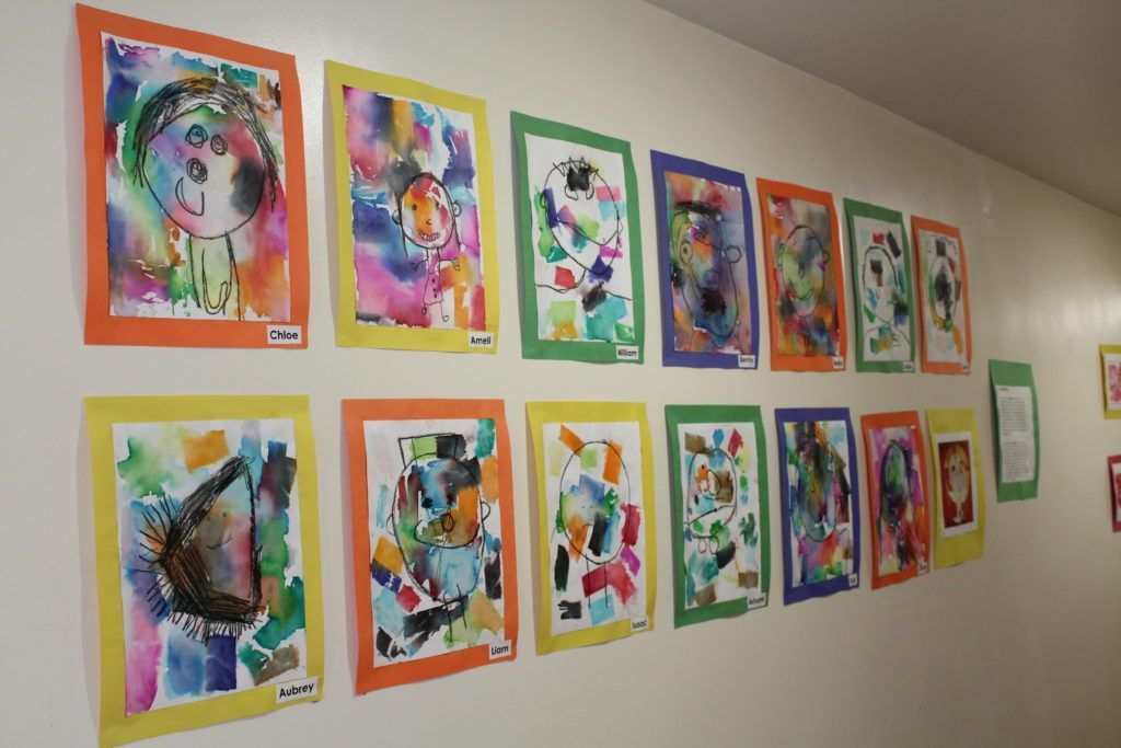 Student watercolor portraits classroom art display