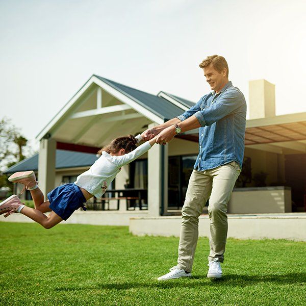 Man Spinning His Daughter Around in Their Backyard — Montgomery, AL — Lawns by Scott