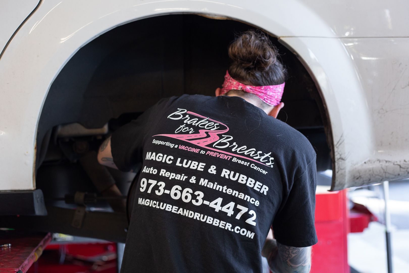  Magic Lube and Rubber technician wearing brakes for breasts tee
