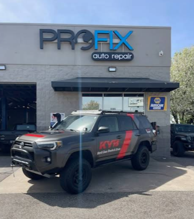 Black SUV Parked Outside Auto Repair Shop With KYB Branding | PROFIX Auto Repair and Leon's PROFIX Auto Repair